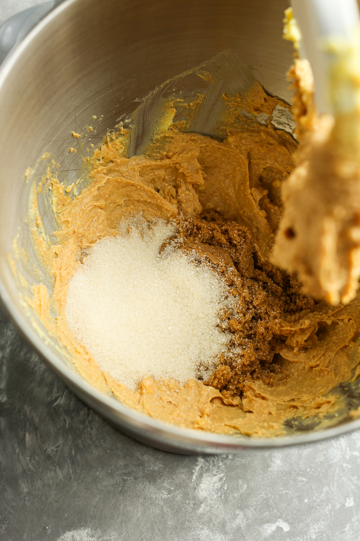 adding sugar to cookie mixture