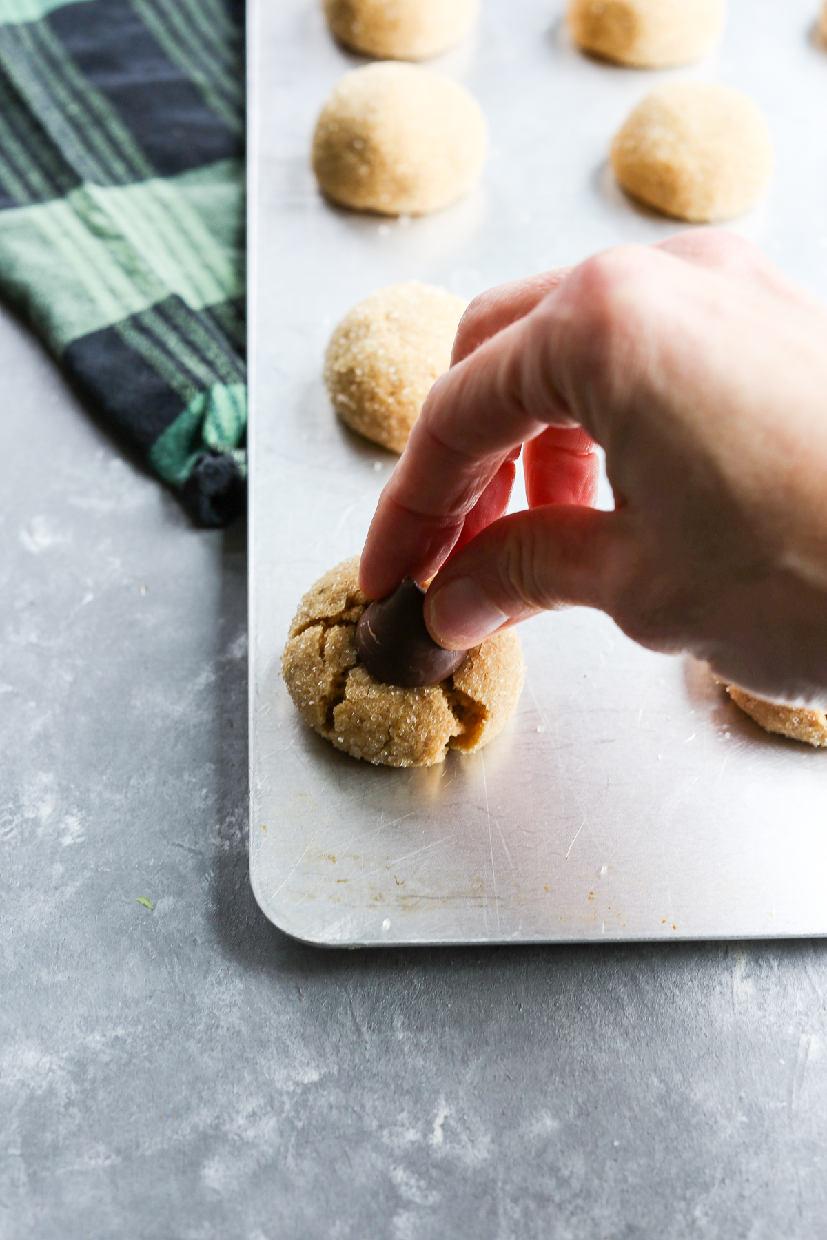 putting a kiss on the top of gluten free peanut butter blossoms