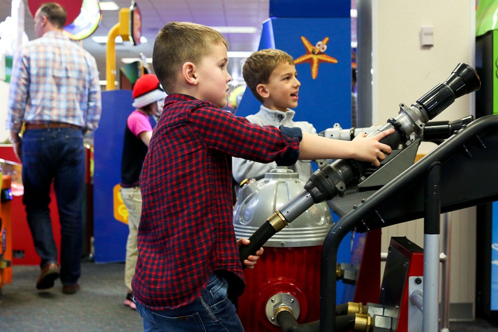 Luke's 6th Birthday Party at Chuck E Cheese's-playing the fire fighting game