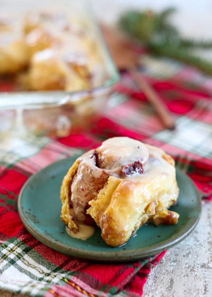 Overnight Cranberry Cinnamon Rolls-on a plate with the pan in the background