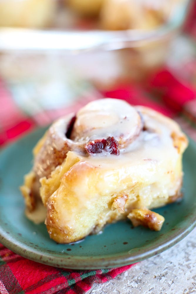 Overnight Cranberry Cinnamon Rolls-one on a plate close up
