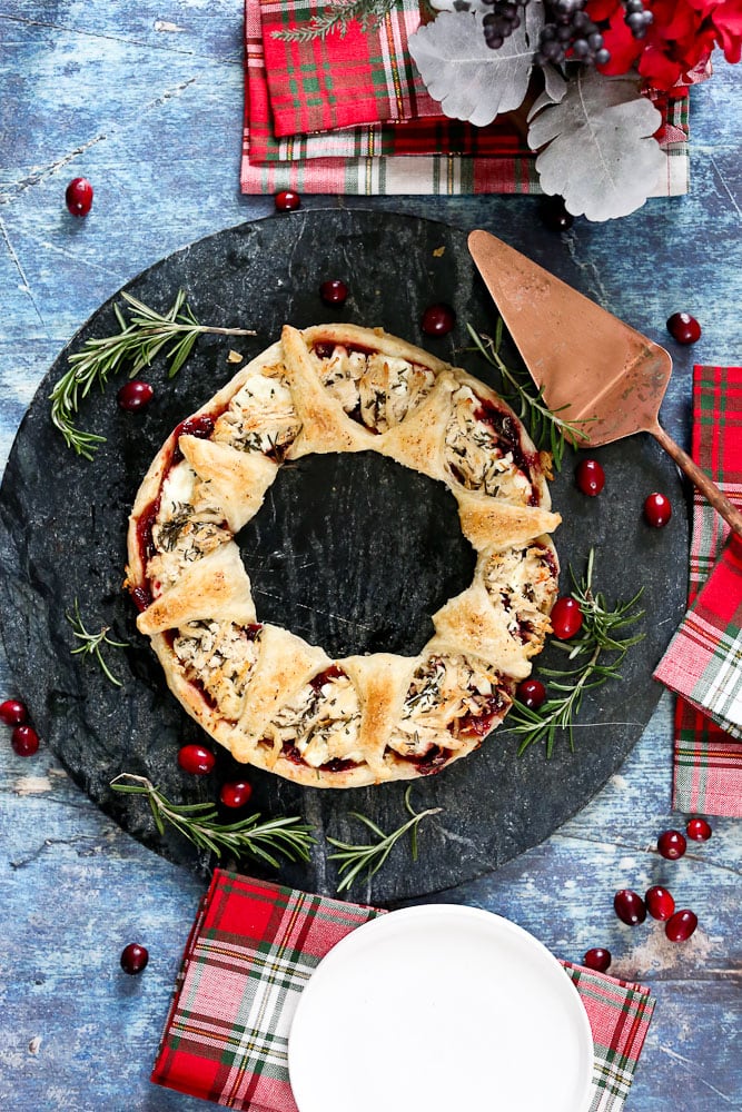 Puff Pastry Christmas WreathAppetizer with Christmas napkins on a serving plate