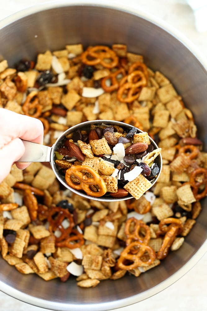 Sweet and Salty Chex Mix Recipe scooping out of a big bowl