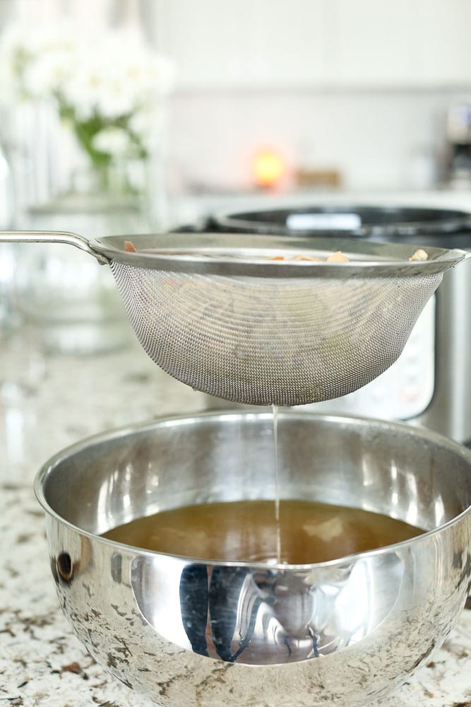 Instant Pot Bone Broth-straining the broth with a fine mesh strainer