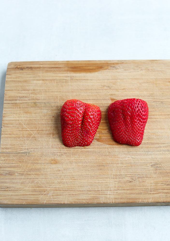 cut the strawberry in half length wise to make a strawberry heart