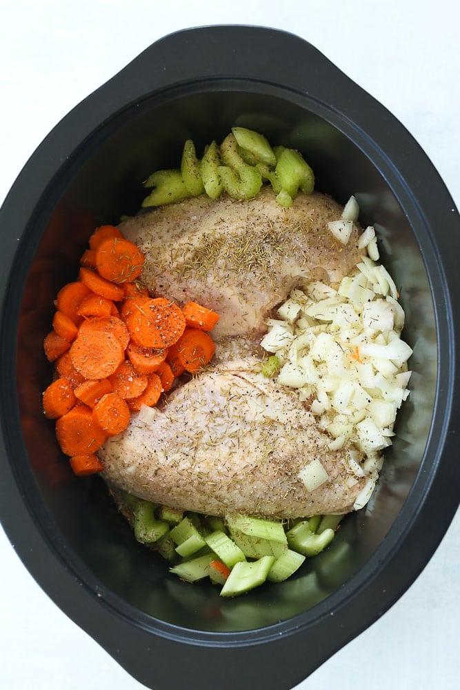 crockpot chicken noodle soup raw ingredients in the pot