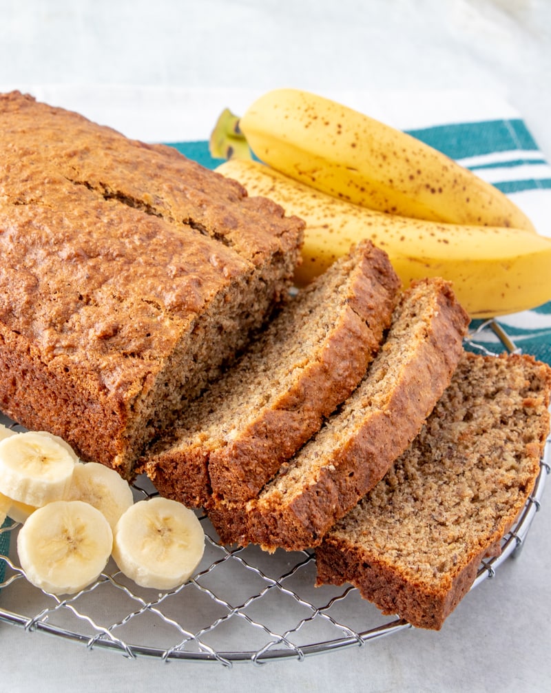 Vegan Banana Bread Recipe sliced with bananas on the side