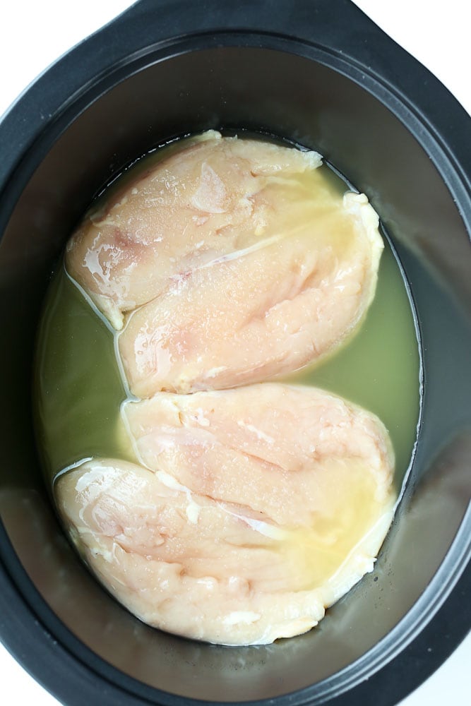 Crockpot Shredded Chicken recipe dinner ideas raw boneless skinless chicken breasts in the slow cooker with broth