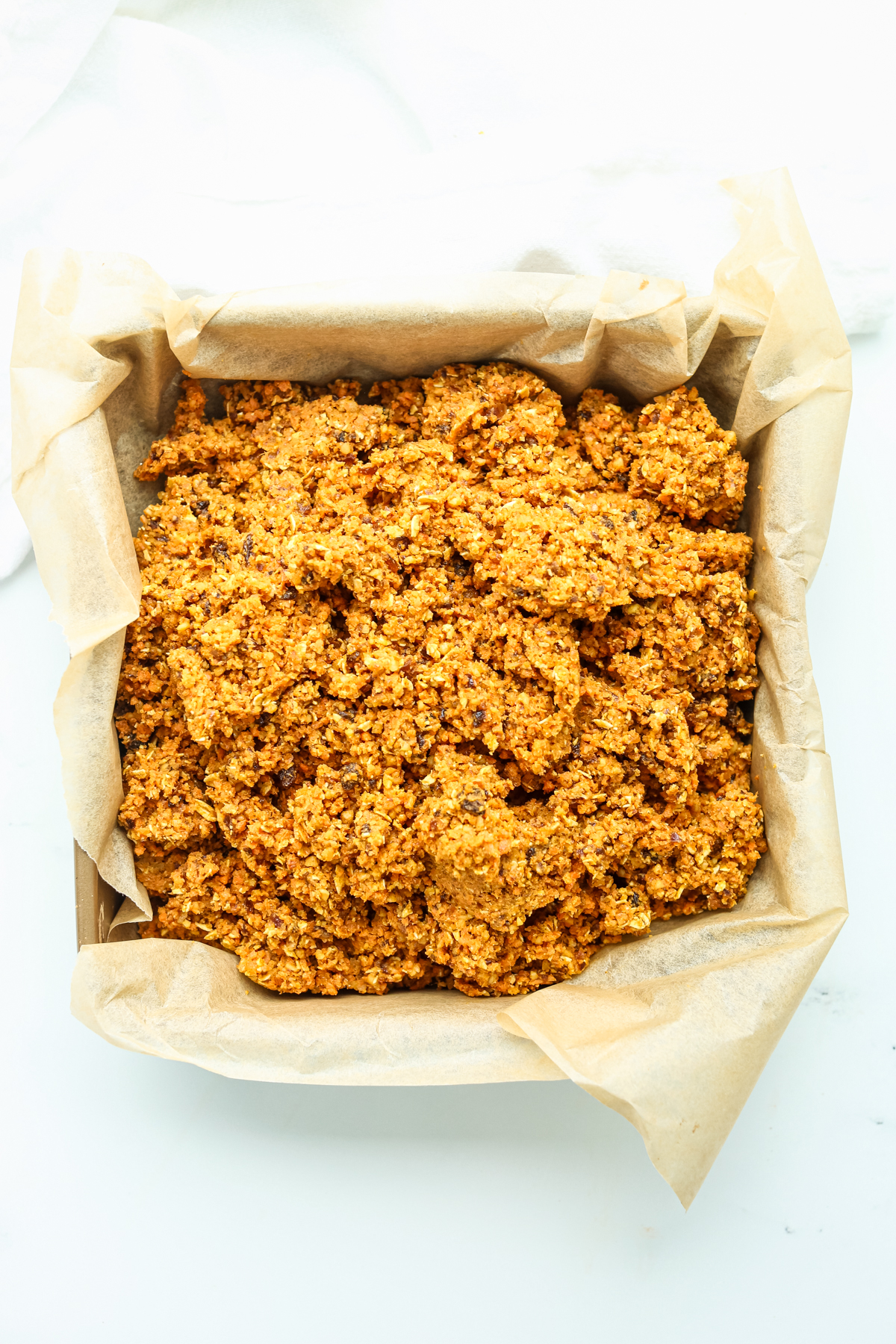 the mixture for healthy carrot cake bars in a pan