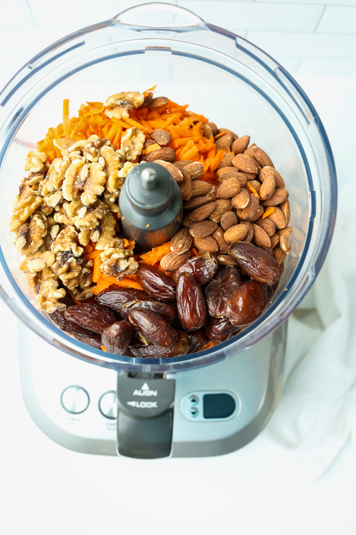 shredded carrots, dates, almonds, and walnuts in a food processor with eh top off