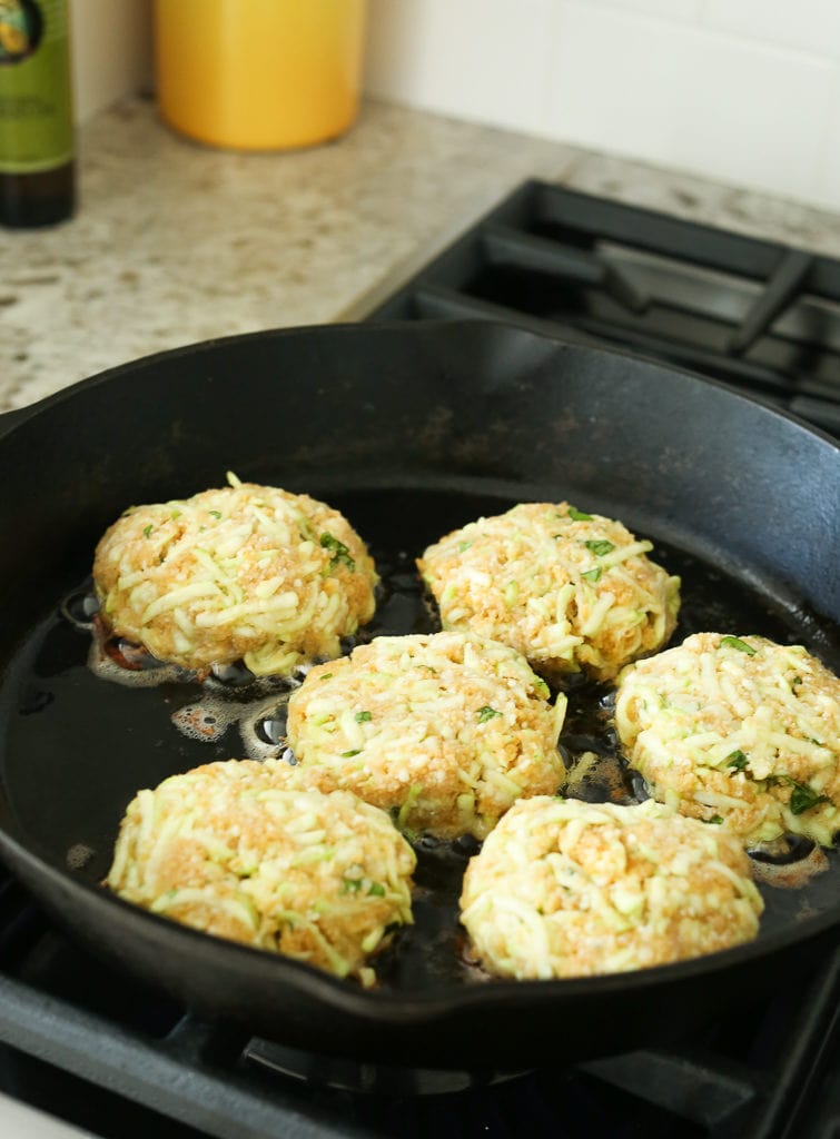 Zucchini Cakes cooking in the cast iron skillet