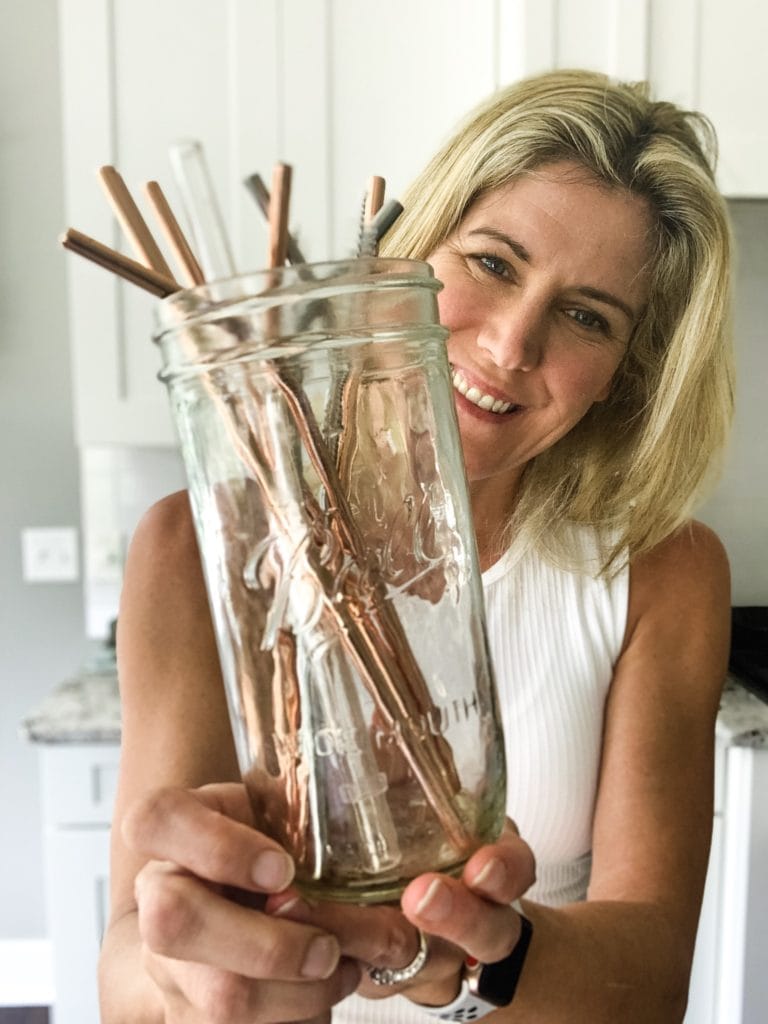 holding the best reusable straws in a glass jar