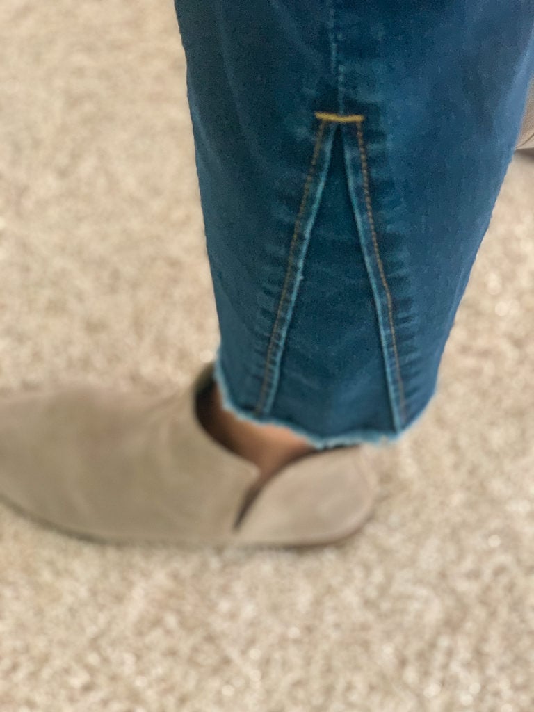 detail of JEN7 jeans at bottom