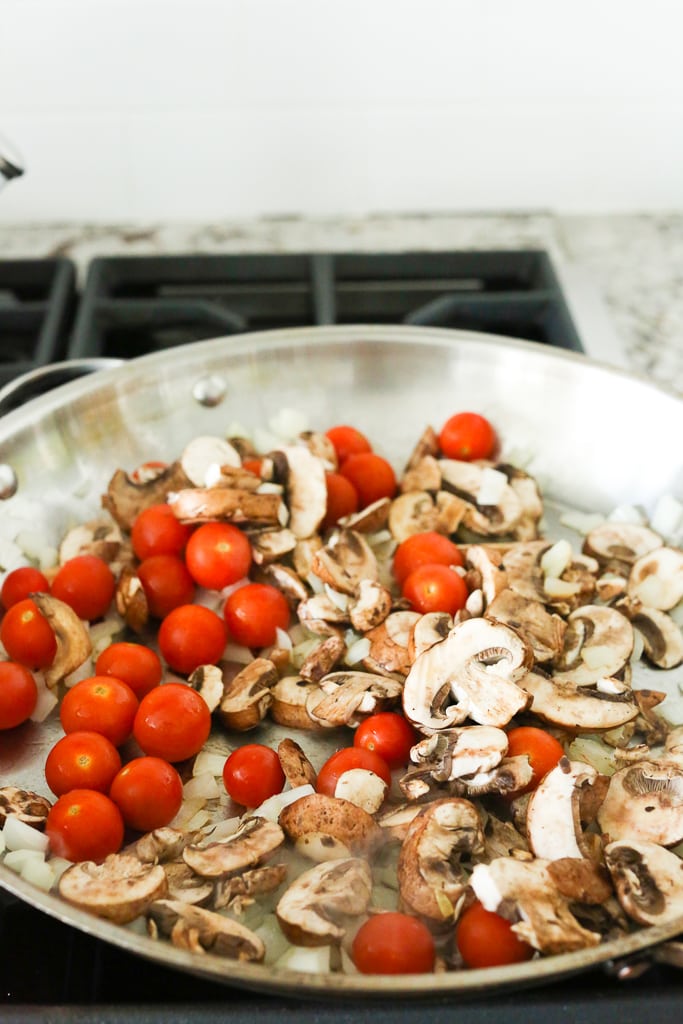 mushrooms and grape tomatoes in a large skillet