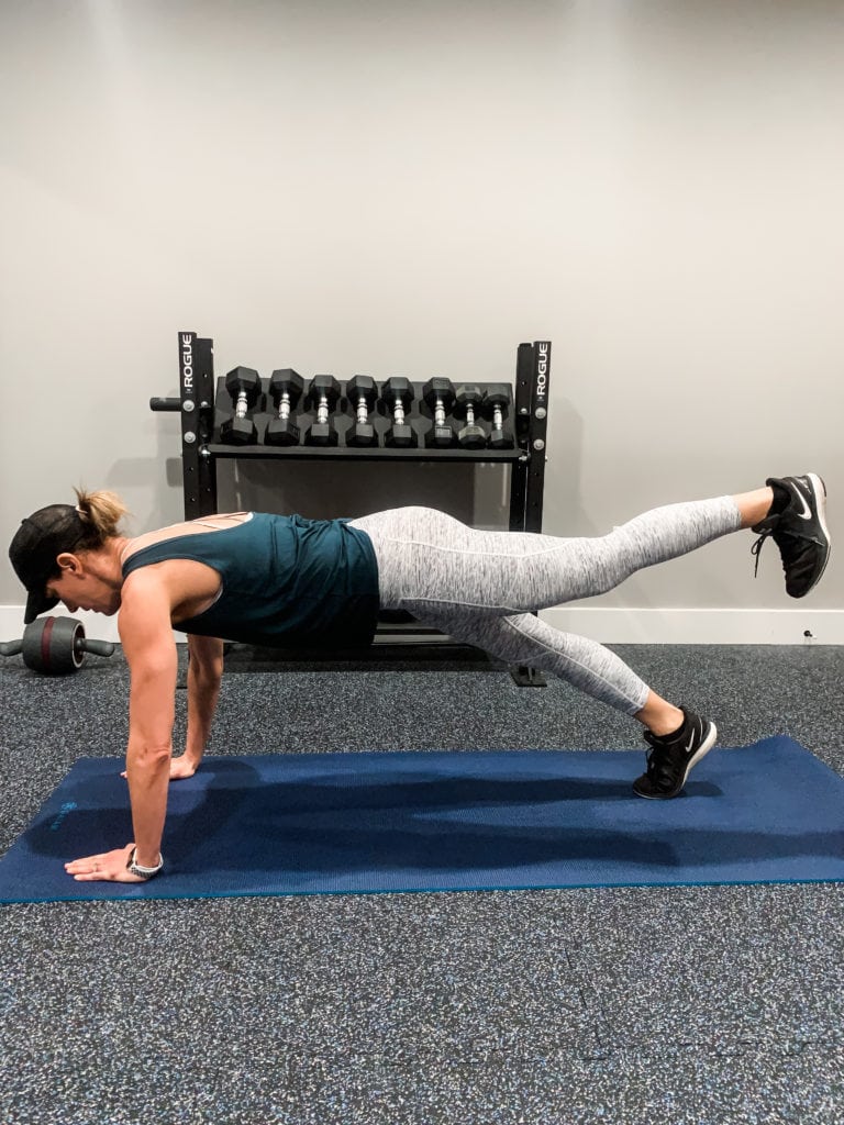 demonstrating plank leg lift