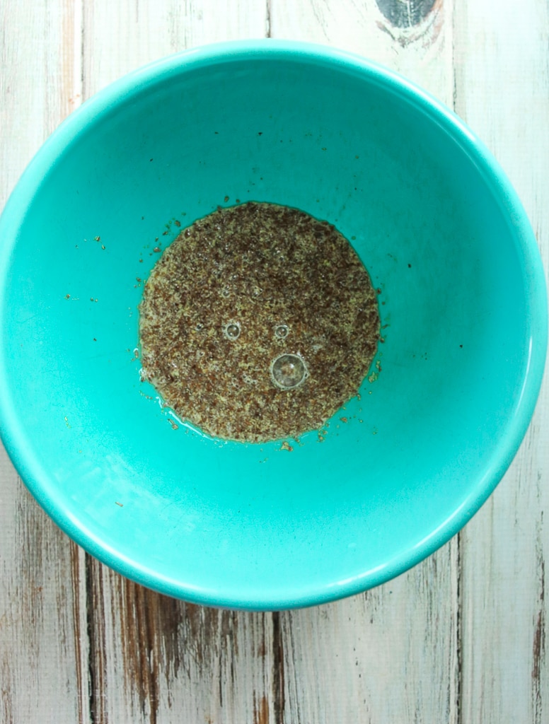 ground flaxseed meal mixed with water in a turquoise bowl 