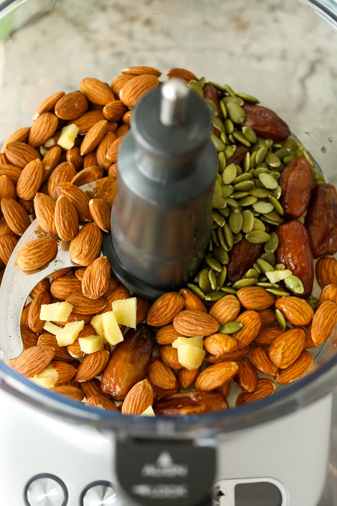 almonds, ginger, pumpkin seeds, and dates in a food processor with the lid off