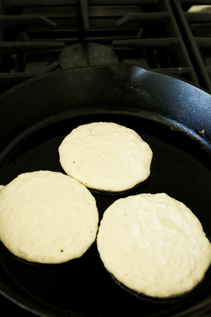 raw pancakes in a skillet