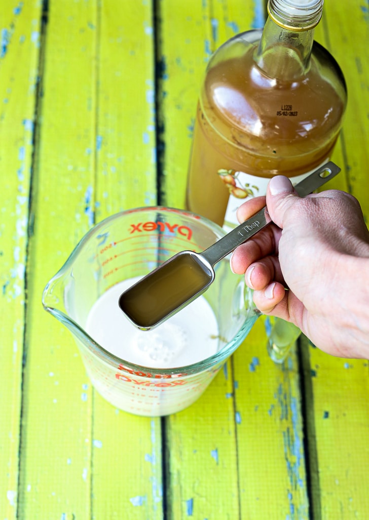 adding apple cider vinegar to almond milk to make a vegan buttermilk substitute 