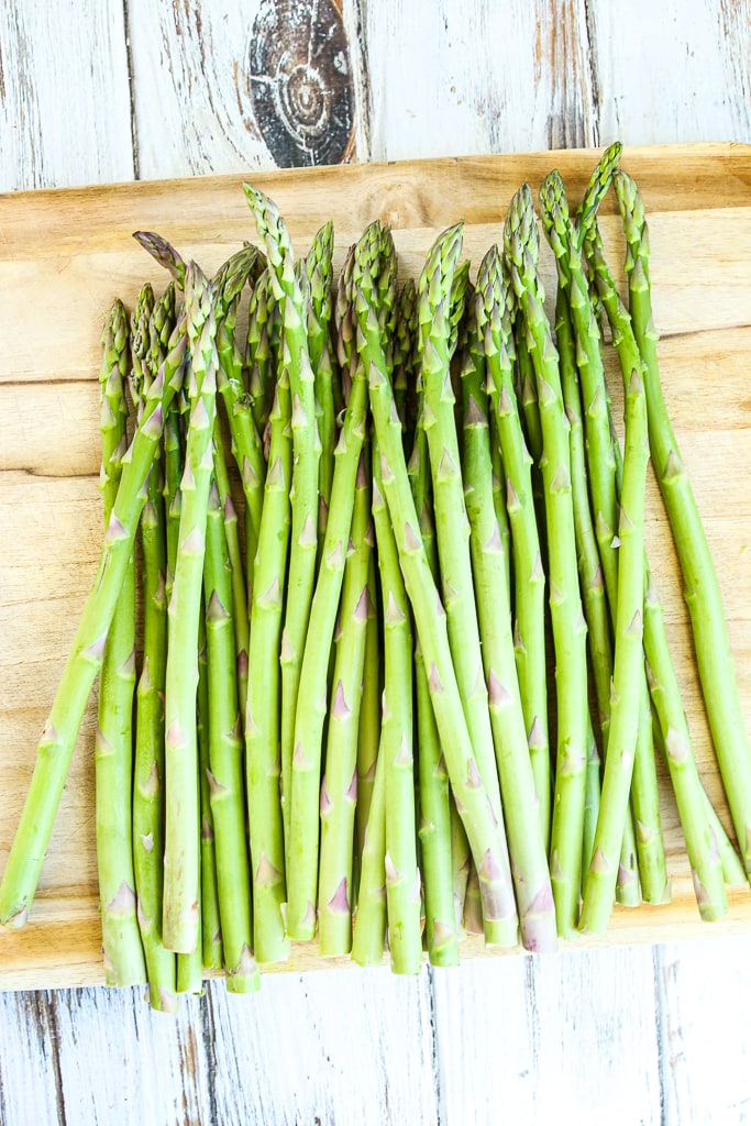 raw asparagus on a cutting board