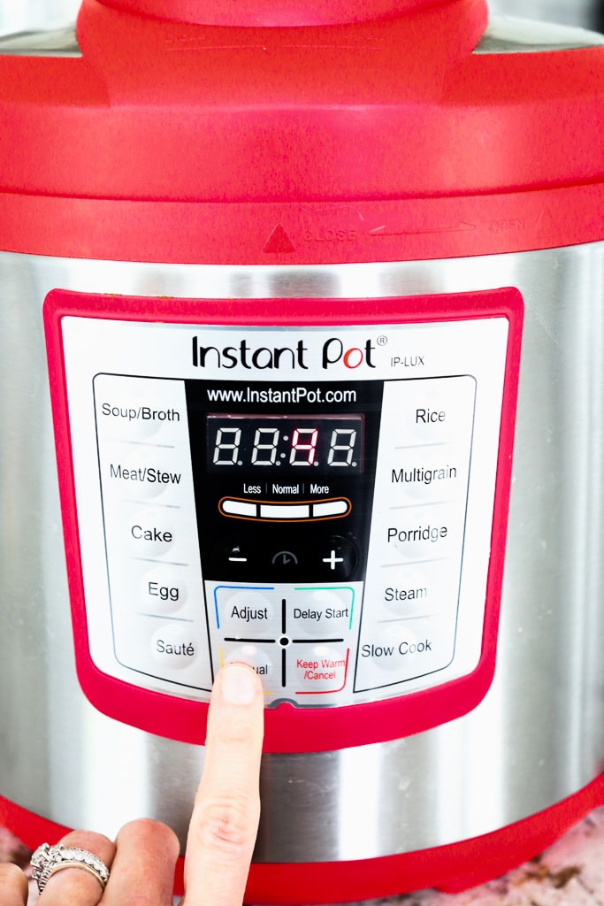 Pressing the button on the Instant Pot