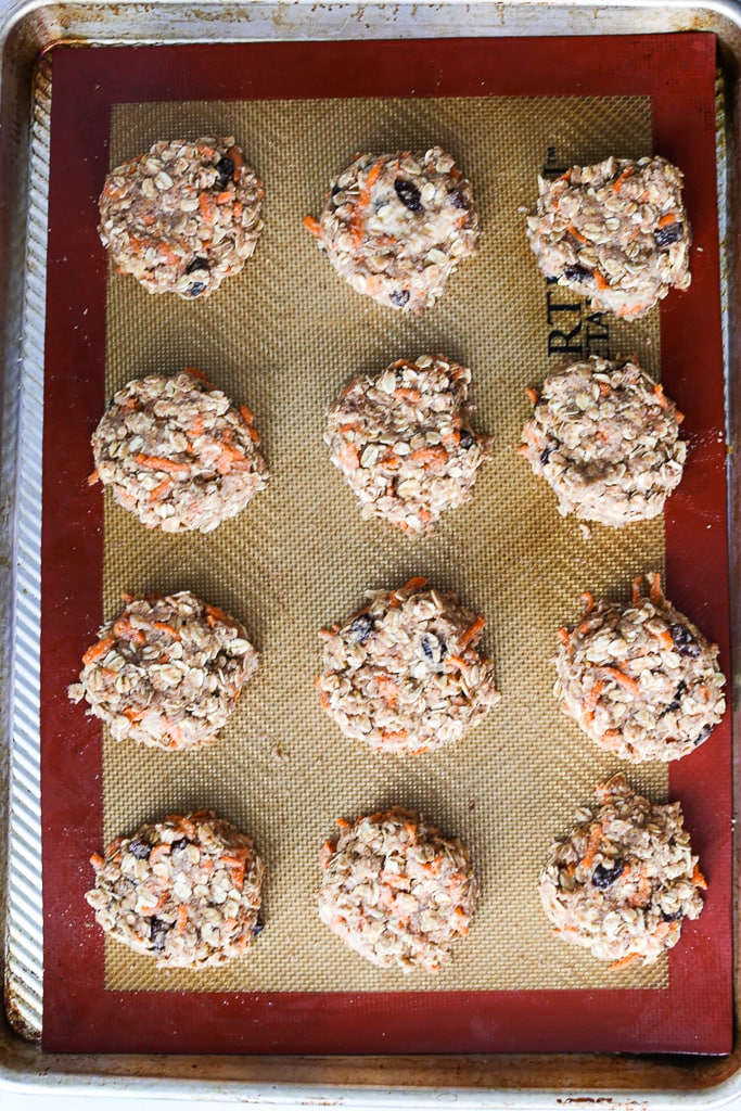 raw carrot cake cookies on a cookie sheet 