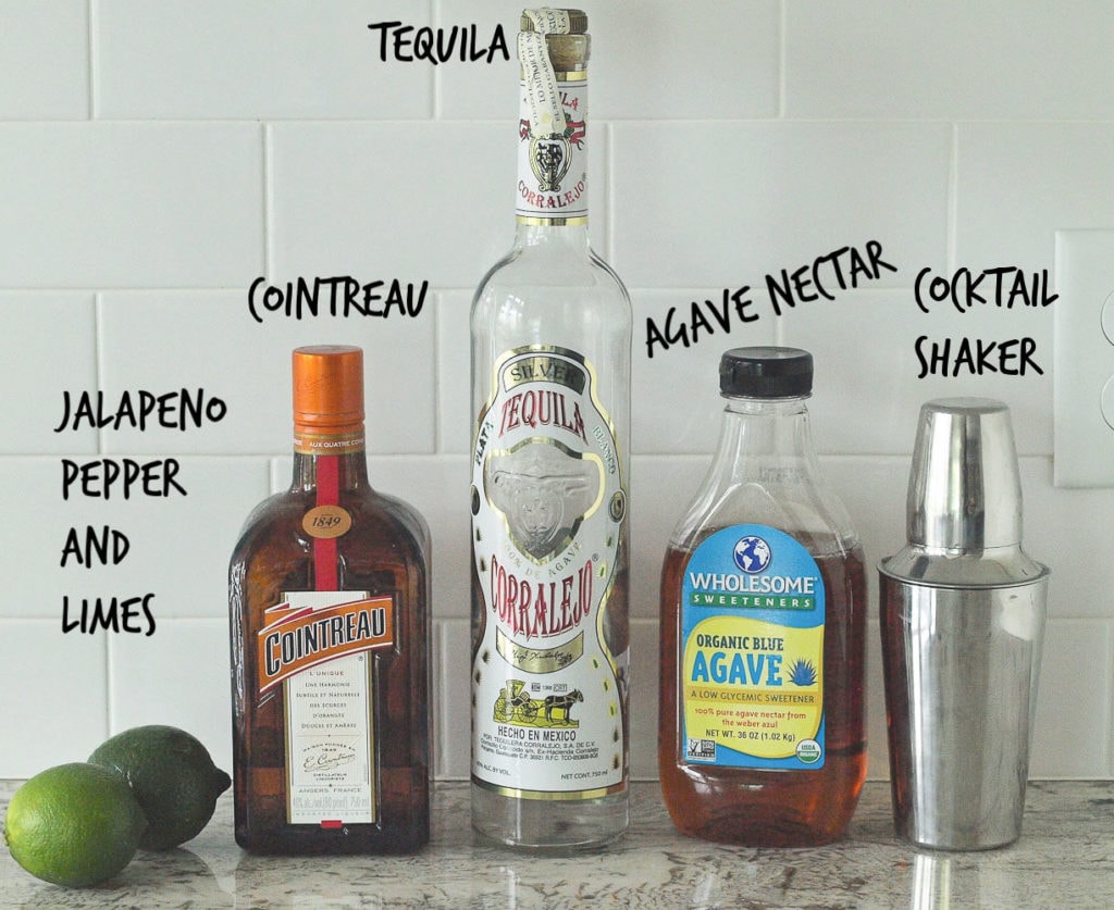 Spicy Jalapeño Margarita Ingredients Picture--showing limes, cointreau, tequila, agave nectar, and a cocktail shaker