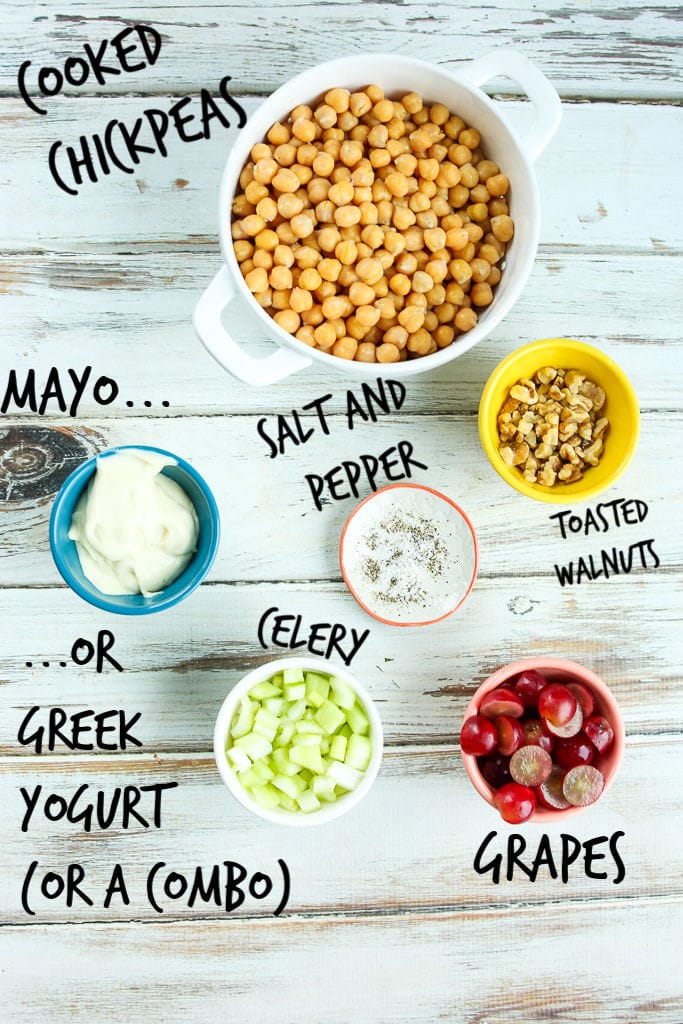 ingredients for the recipe overhead shot: chickpeas, grapes, celery, mayo, walnuts, salt, pepper
