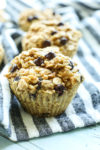 a close up picture of Peanut Butter Chocolate Chip Baked Oatmeal Muffin Cup with a striped napkin underneath
