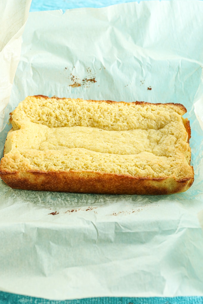 cake removed from pan sitting on top of the parchment paper