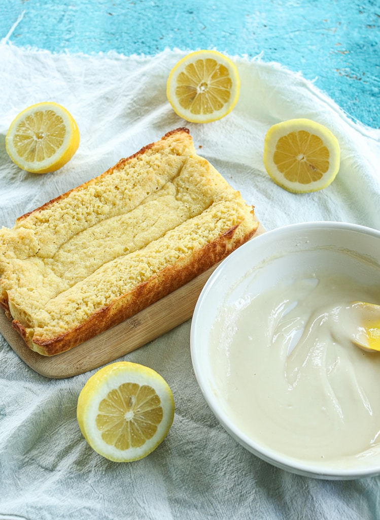 the glaze in a bowl ready to be spread on the lemon loaf cake