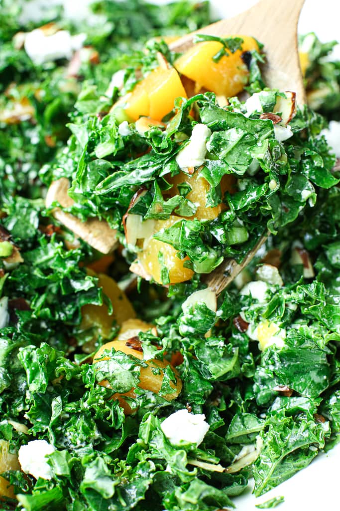 close up picture of easy kale salad being served with a serving spoon