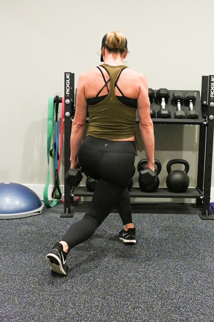 a woman performing cross behind lunges