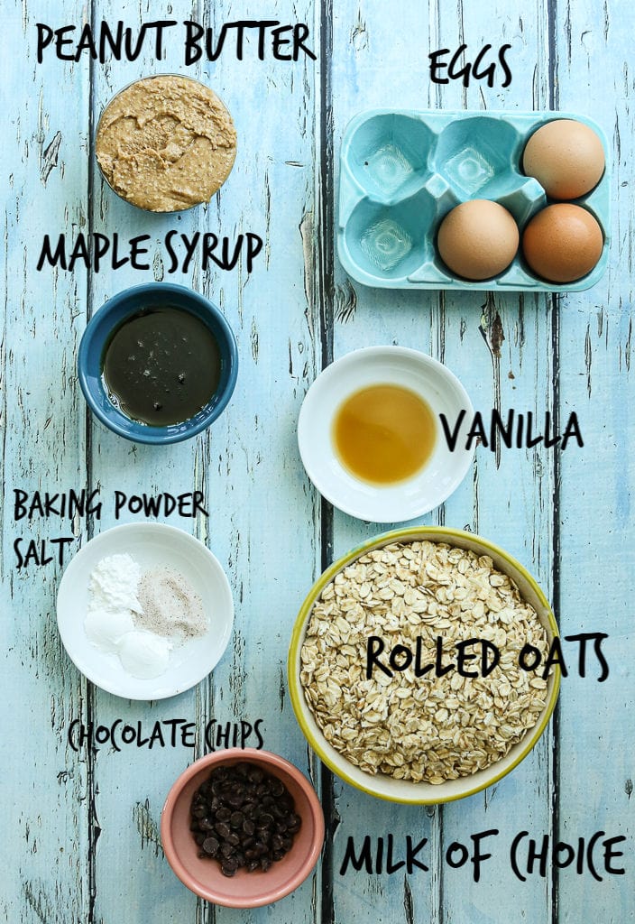 Ingredients overhead shot peanut butter, maple syrup, baking powder, salt, vanilla, rolled oats, milk and chocolate chips