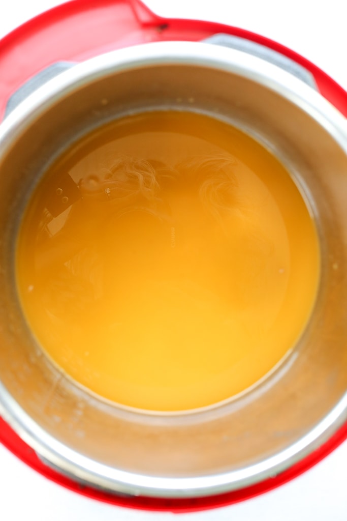 overhead shot of farro and vegetable broth in the Instant pot