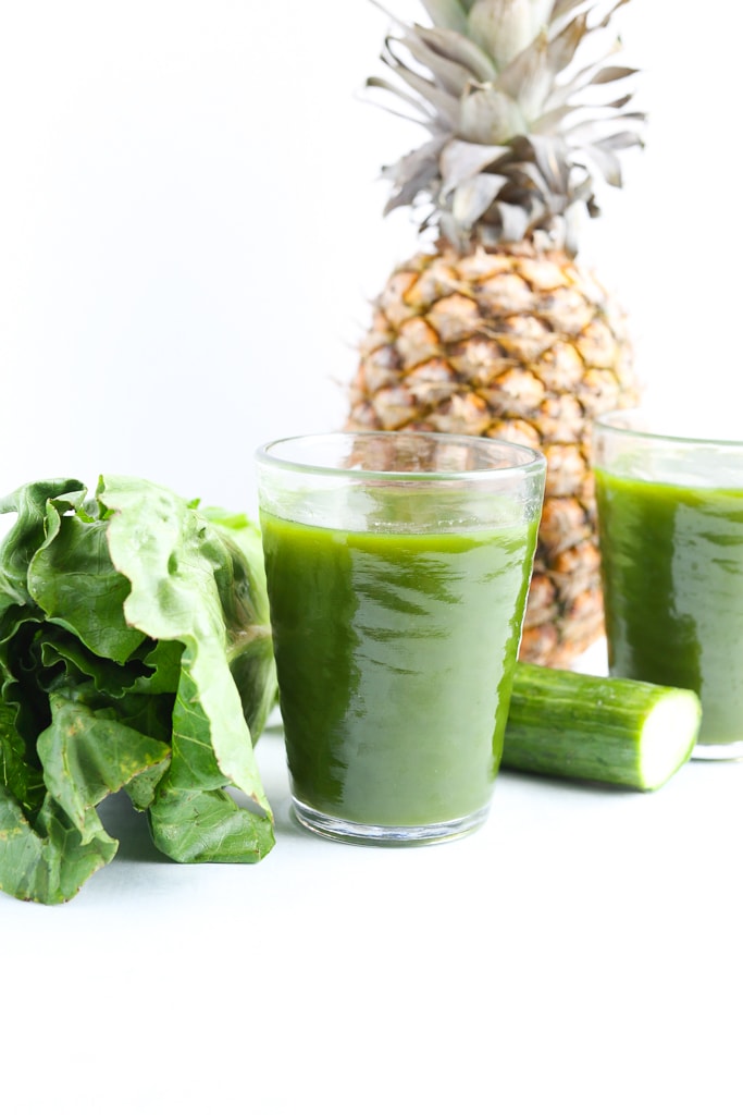 2 glasses of green juice with pineapple, romaine, and cucumber