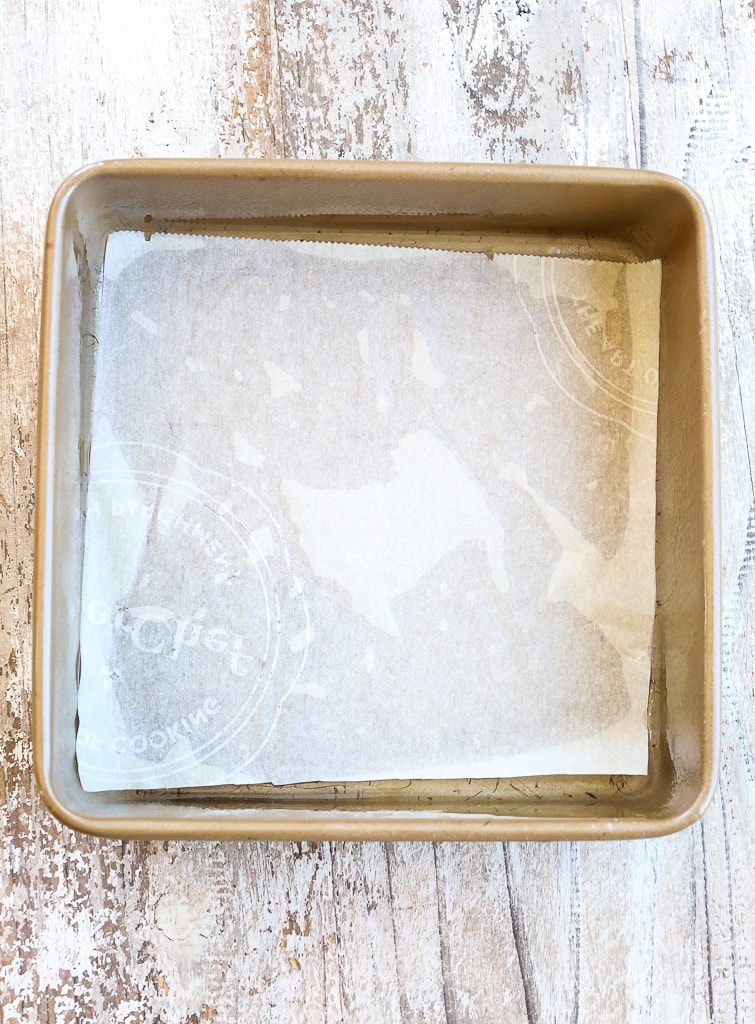 a square baking pan with parchment paper