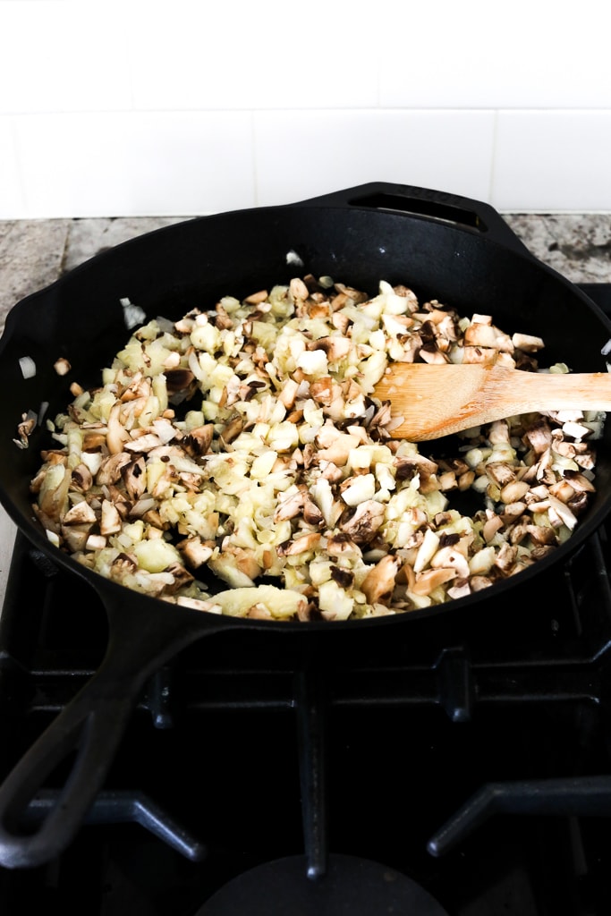 cooking the onions, mushrooms, and zucchini pulp in a pan