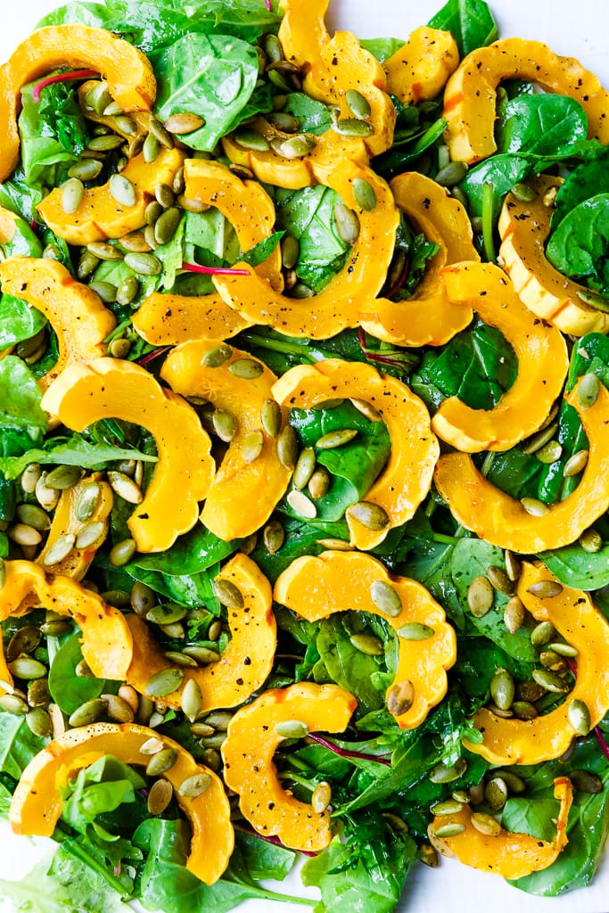 greens with roasted delicata squash on top