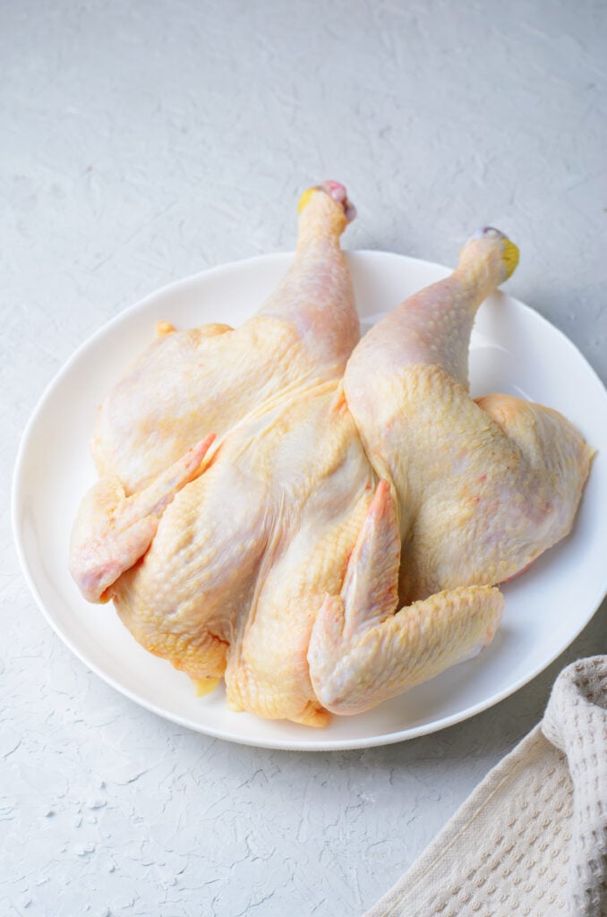 how to spatchcock a chicken--showing the raw chicken