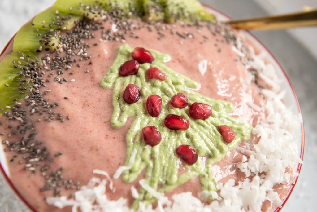 close up shot of a pink smoothie bowl with a green christmas tree topping