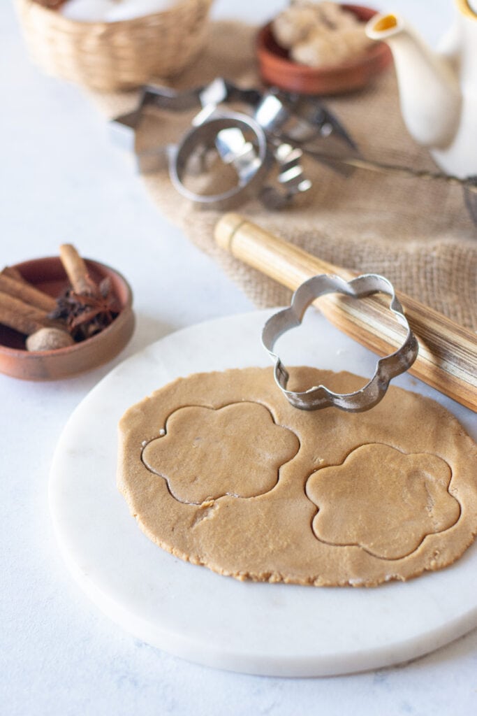 dough flat and a cookie cutter cutting out the shape