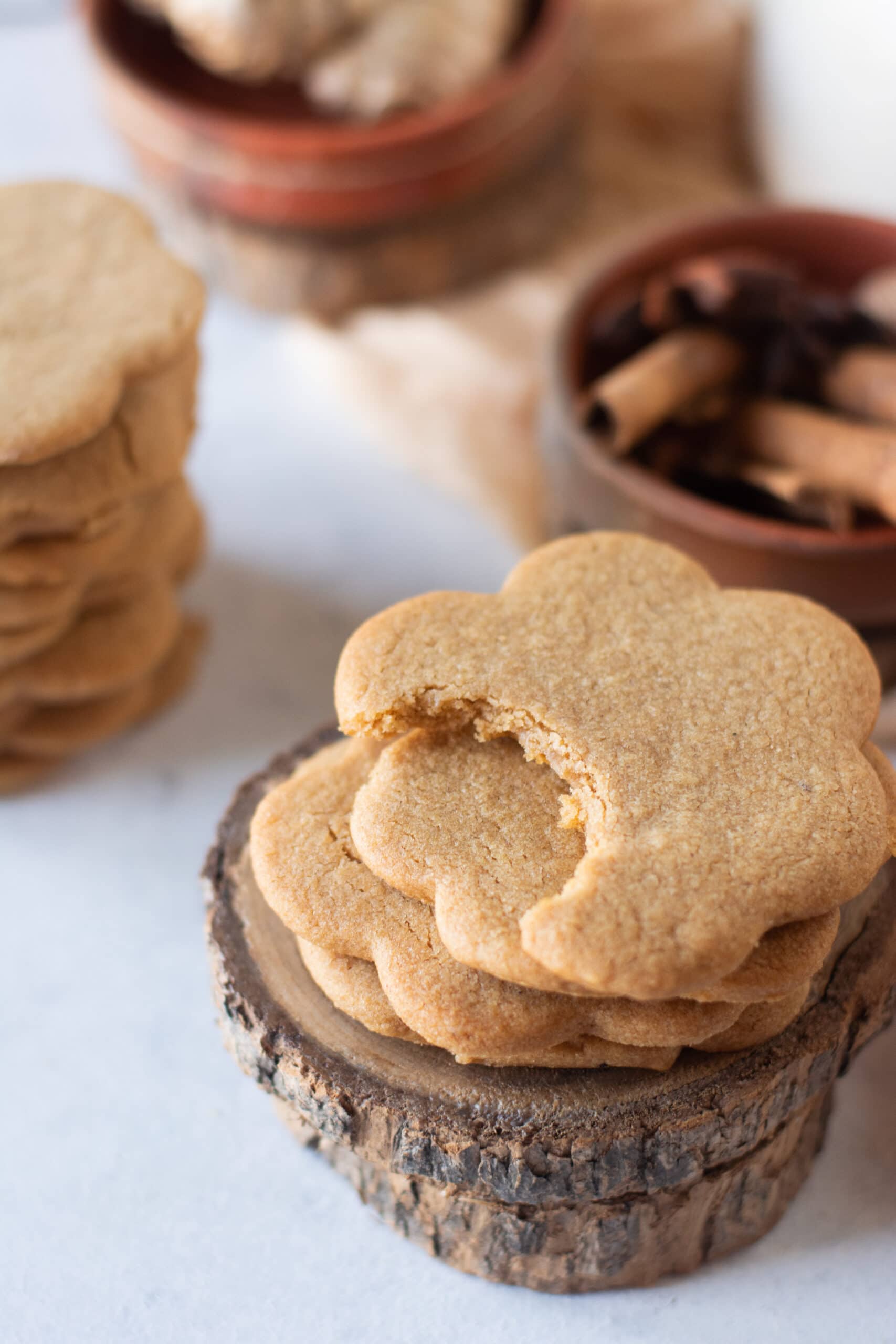 a stack of gingerbread cookies with a bite out of the top cookie
