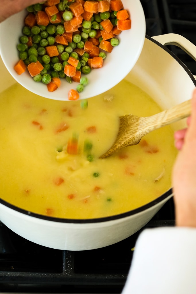 adding frozen vegetables to the Greek Lemon Chicken Soup