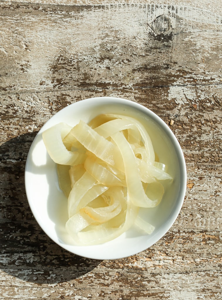 a white bowl of caramelized onions after 25 minutes