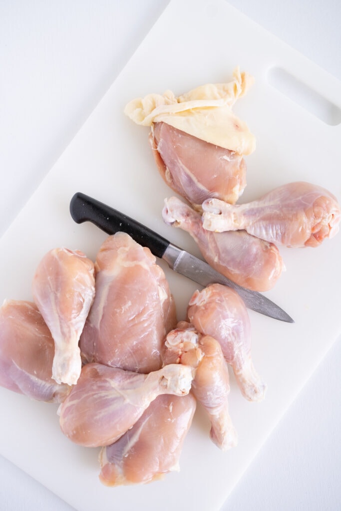 cutting raw chicken