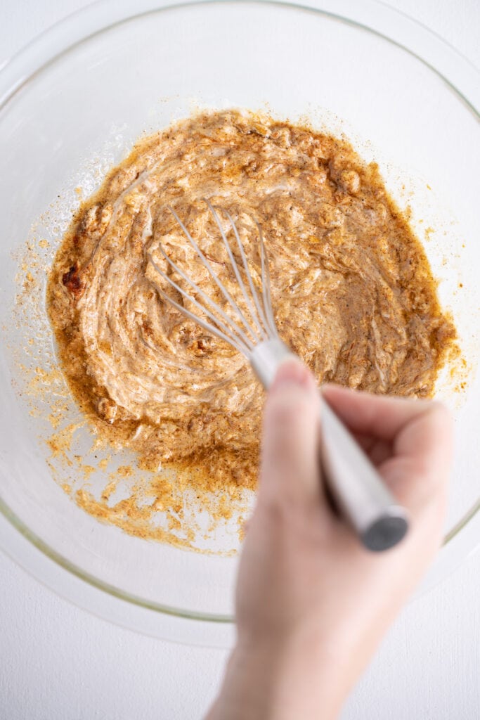 whisking the marinade for tandoori chicken recipe