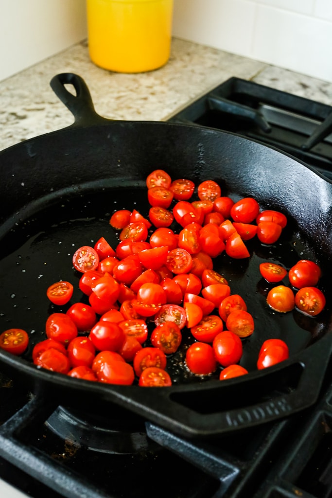 grape tomatoes in a cast iron skillet