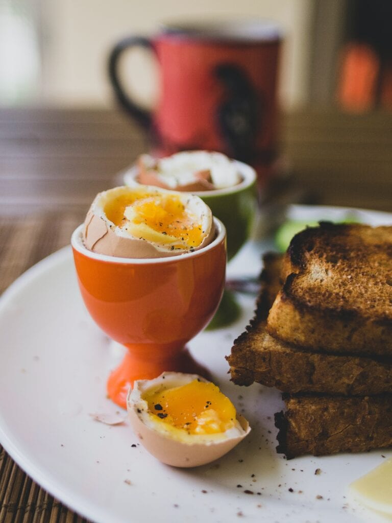 a soft boiled egg in a stand with toast