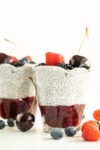 chia pudding in a glass with chia jam and berries
